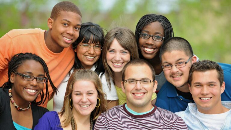 A group of adults with autism enjoying time together in a relaxed outdoor space