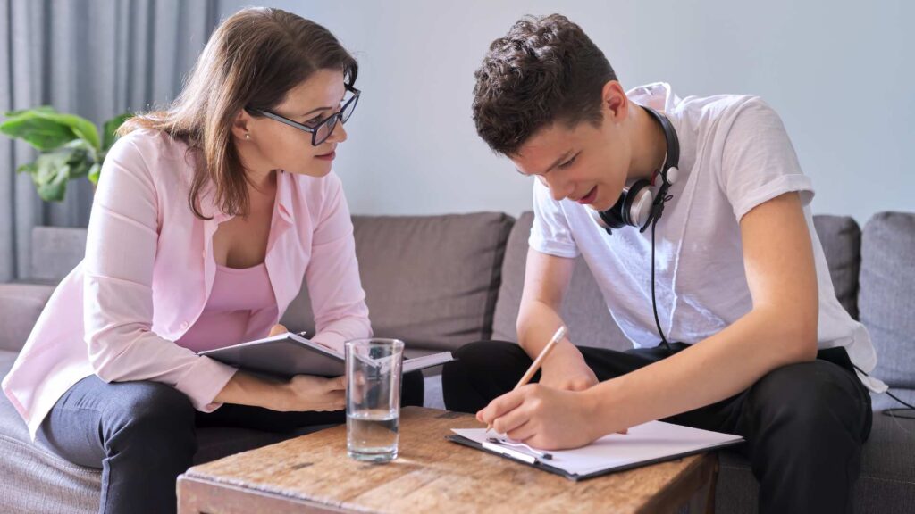 A teenage boy with his therapist reflecting about the question "Am I on the Spectrum"