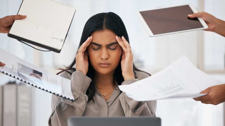 Burnout in BCBAs shown by a Board Certified Behavior Analyst feeling overwhelmed by workload and clinical demands.