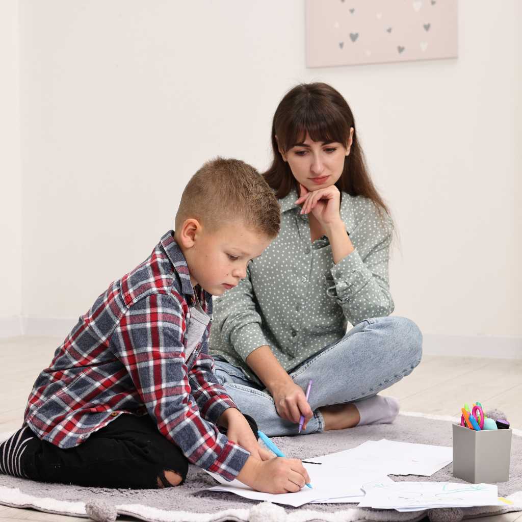 BCBA experiencing burnout while supporting a child during therapy, highlighting workload and emotional strain in behavior analysis.