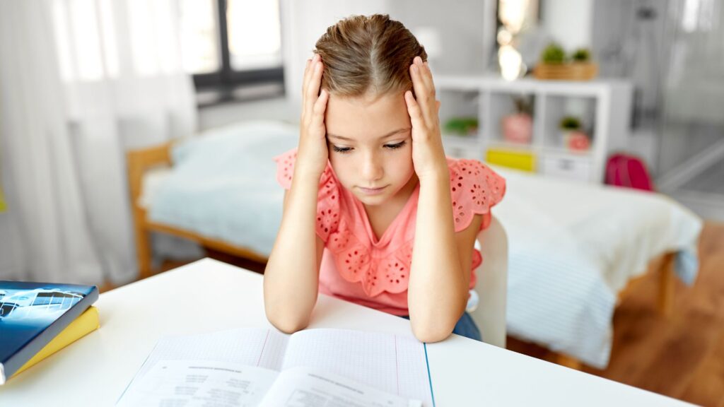 Child feeling overwhelmed while working on school assignments