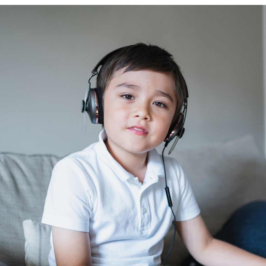 Young child wearing headphones to help with back-to-school anxiety