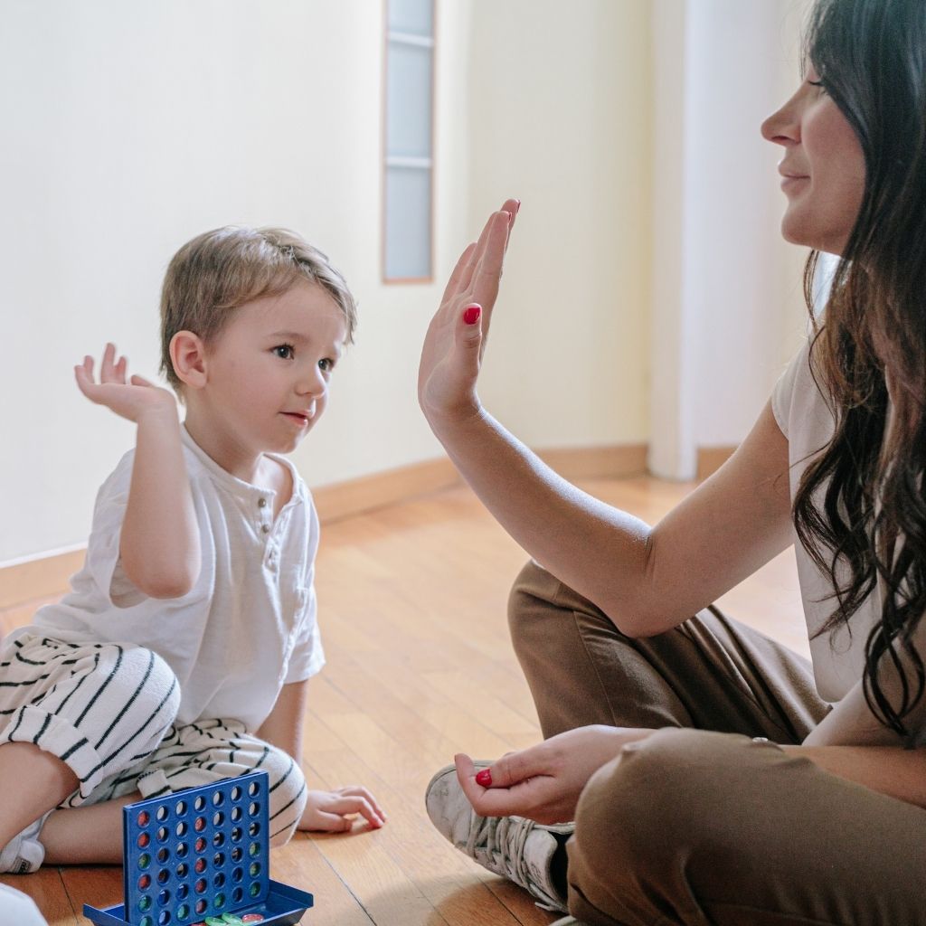 Parent and young child practicing a skill together during play
