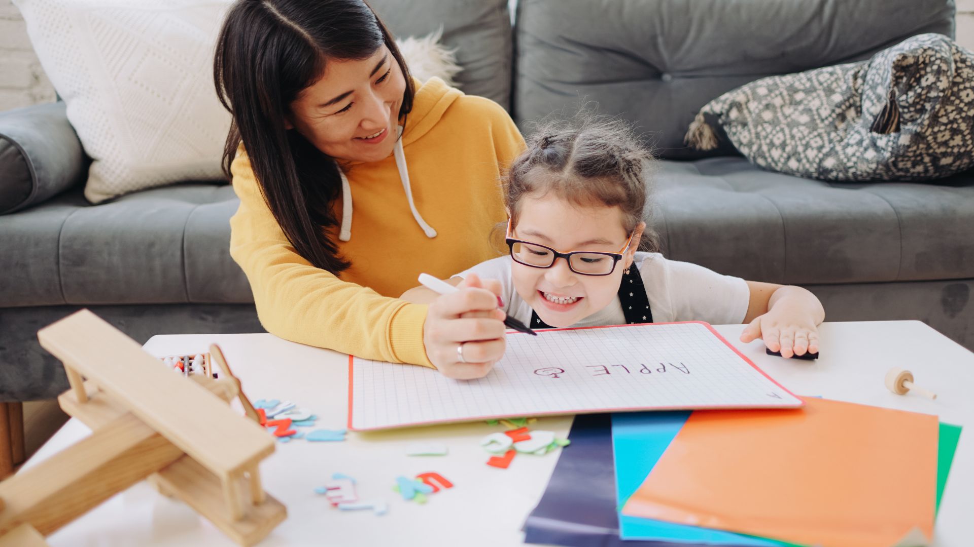 Parent helping child with a learning activity at home
